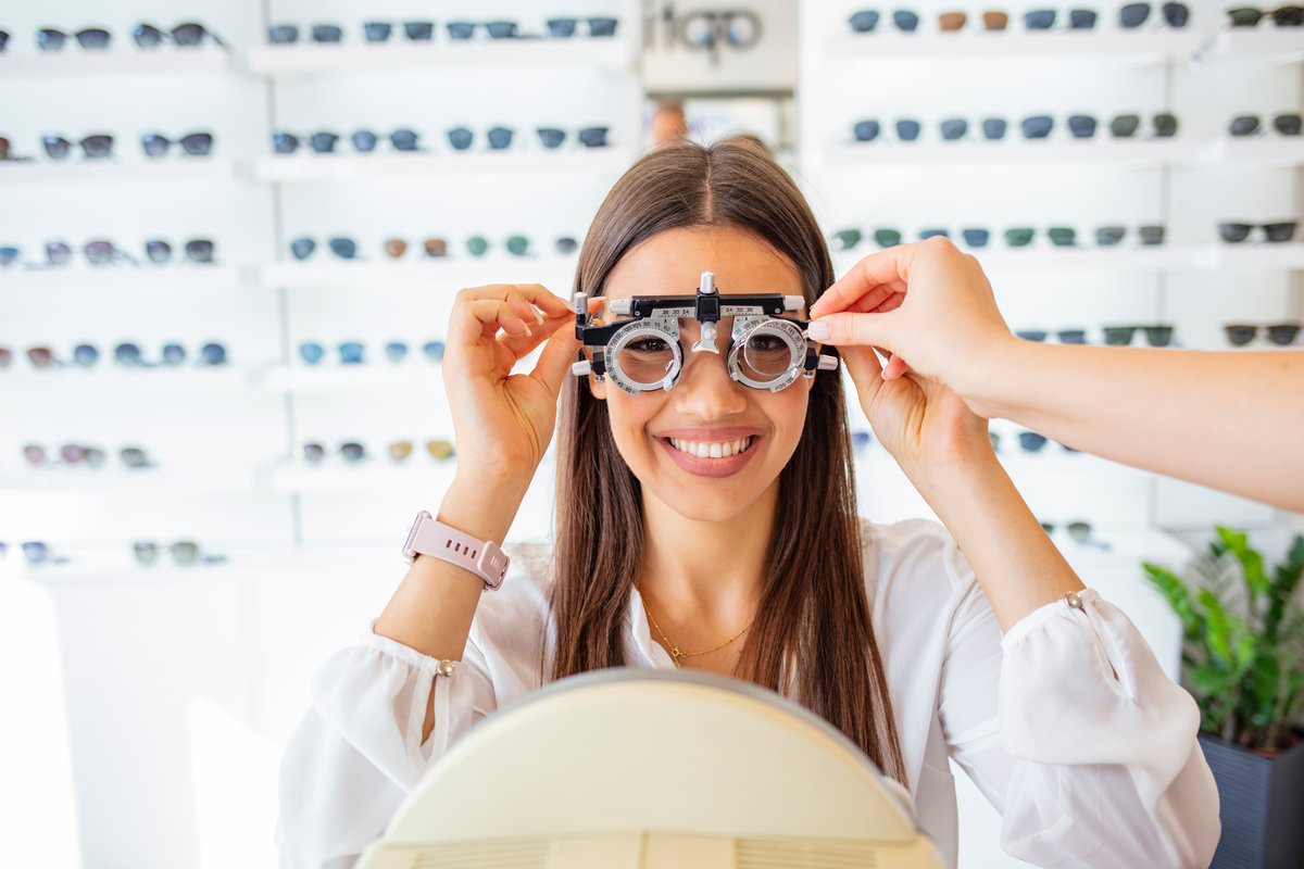 Smiling Woman Undergoing Eye Examination at Optometrist Office