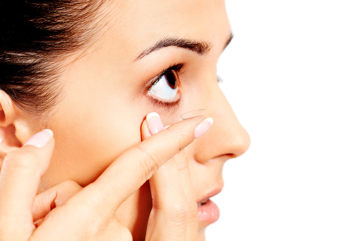 Closeup of young woman wearing contact lens