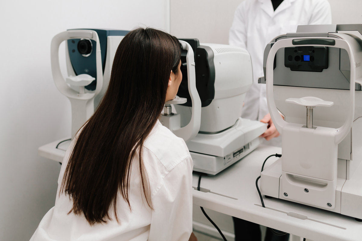 Eye exam with modern autorefractor and OCT machines. Autorefractor measures refractive errors, helping determine prescriptions for glasses or contact lenses with high accuracy and efficiency