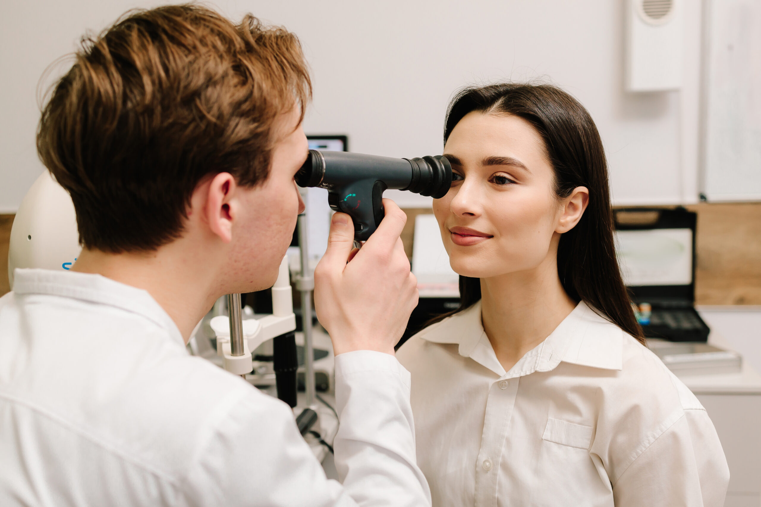 Ophthalmoscopy. Ophthalmologist examines the eyes of woman with ophthalmoscope. Ophthalmology consultation with an optometrist in a medical clinic