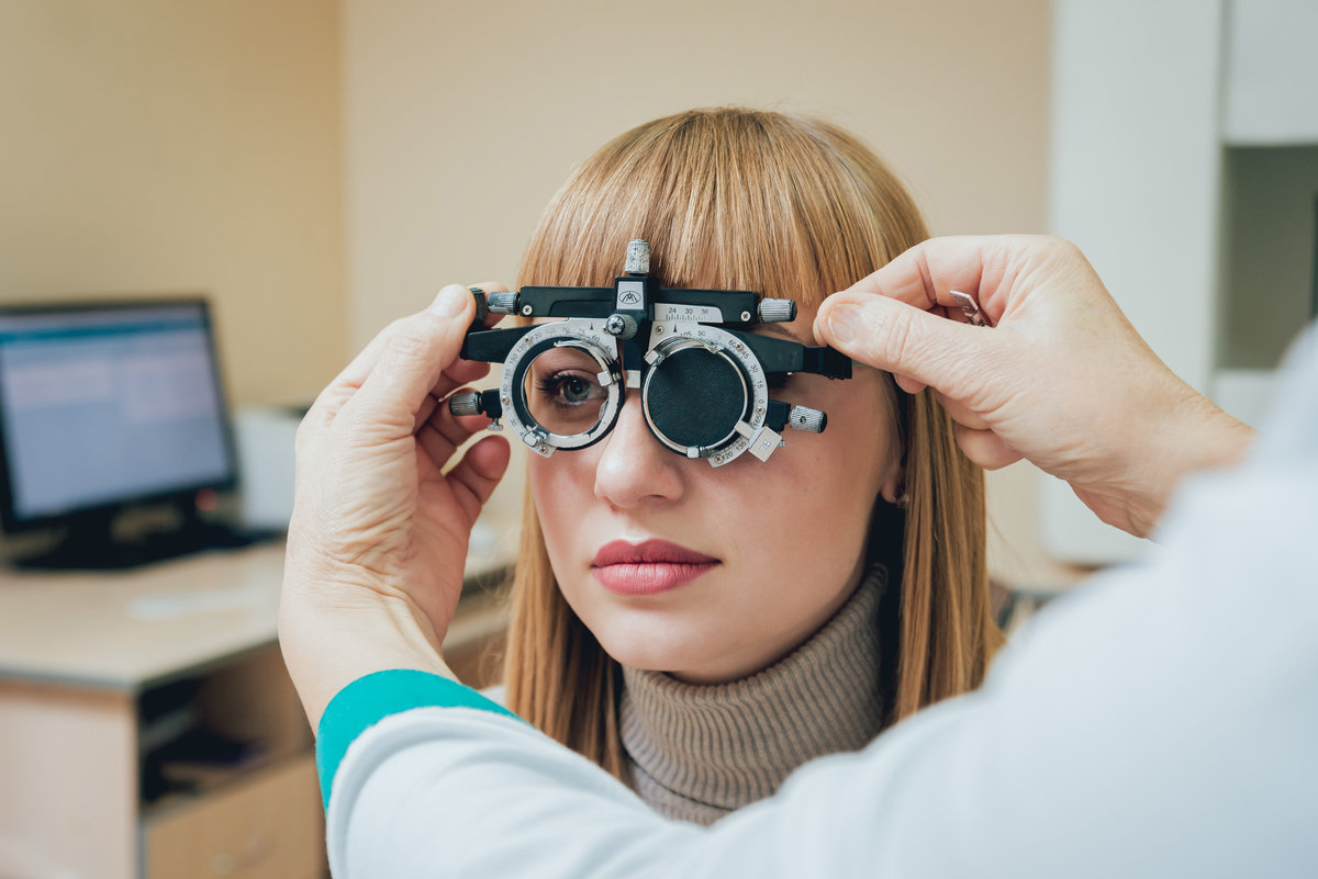 Trial frame. Glasses for a young woman. Hypermetropia. Ametropia correction with glasses.