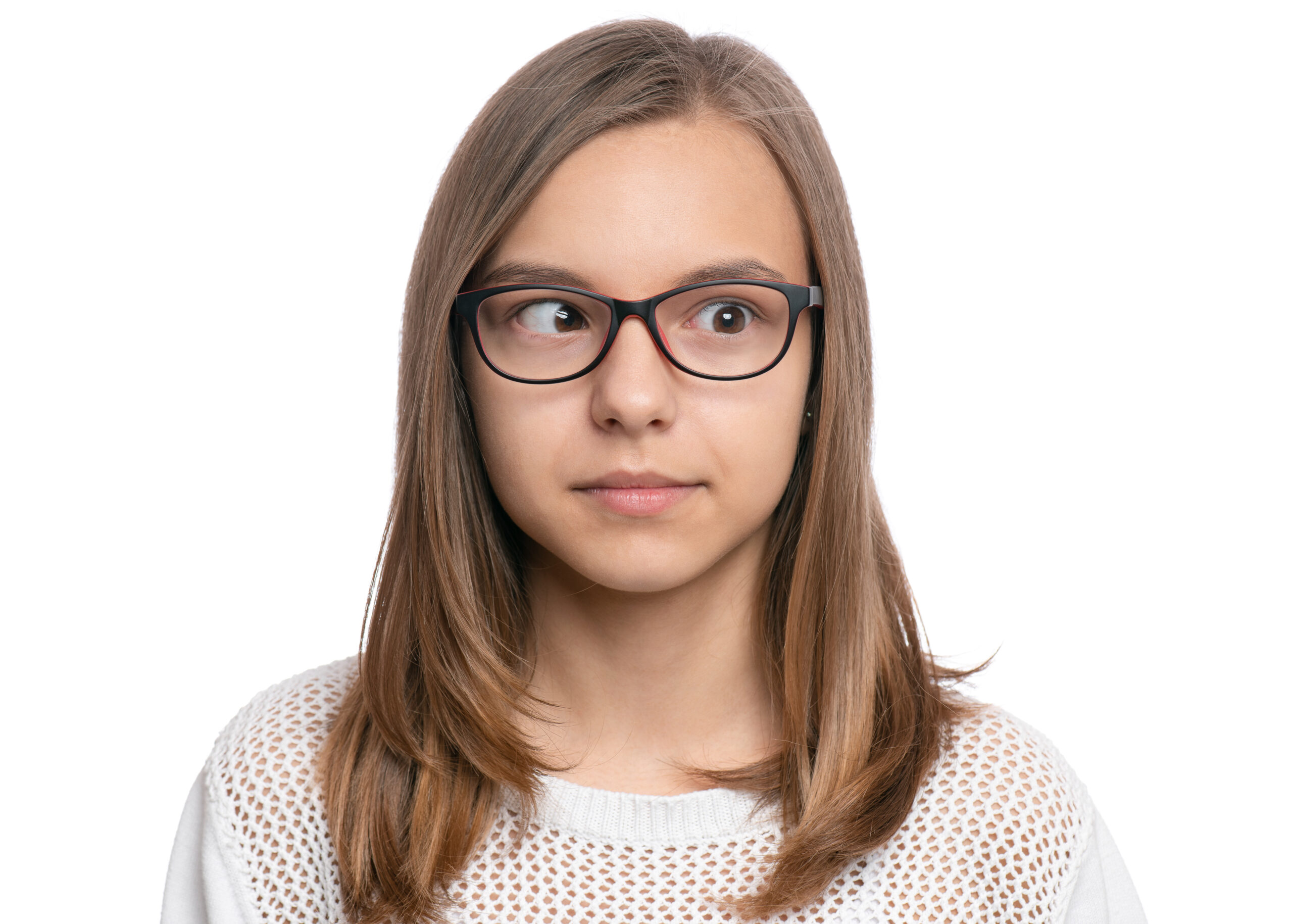 Crazy child making grimace - Silly face. Funny caucasian teen girl in eyeglasses, isolated on white background. Close-up portrait.