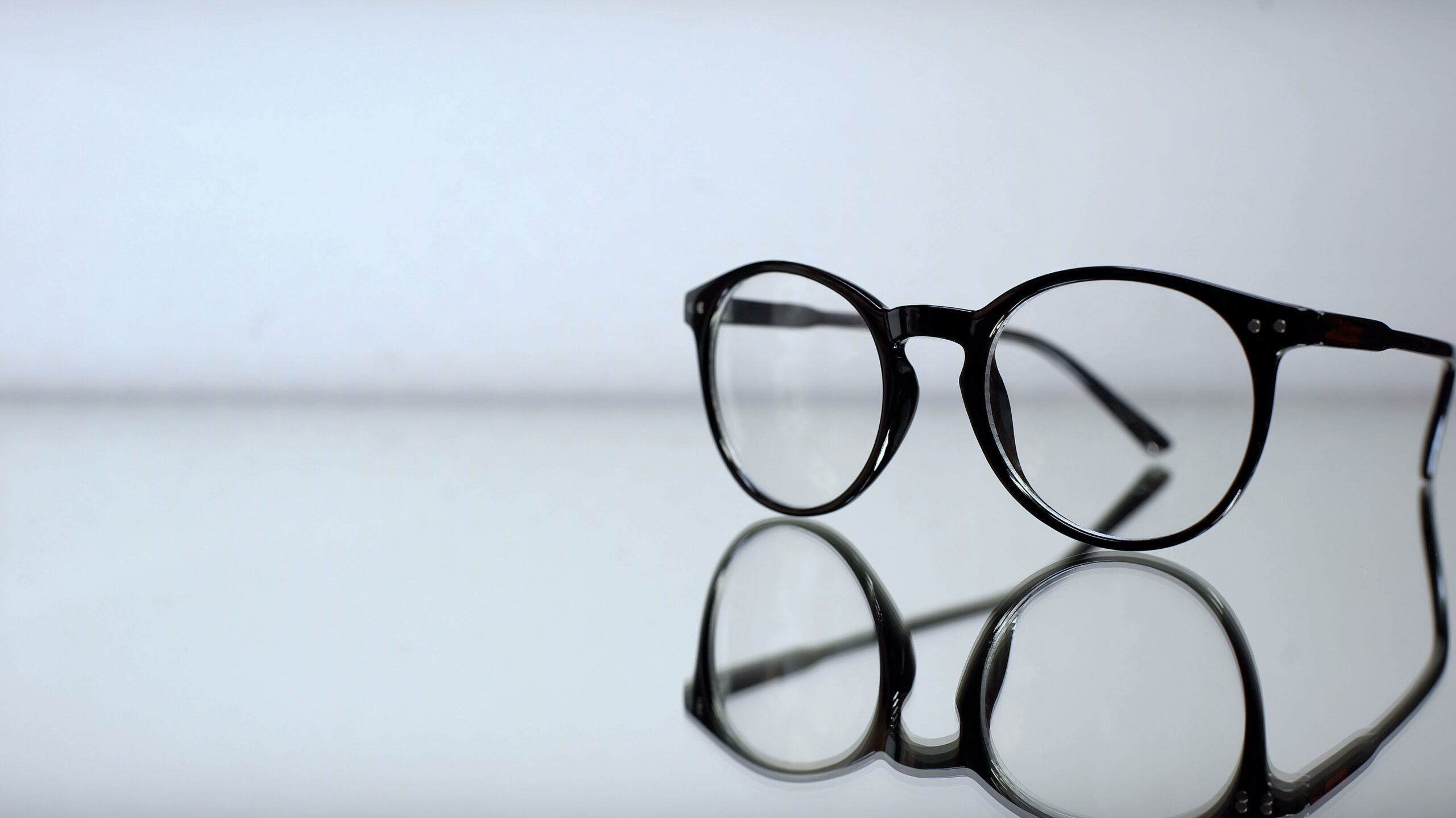 Classic eyeglasses with diopters on table in ophthalmologist office, diagnostics