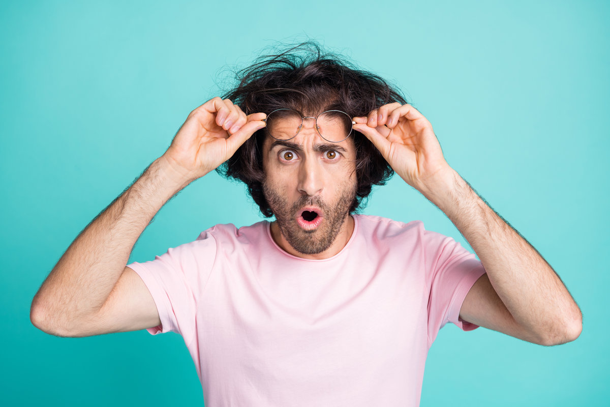 Close up photo of scared person open mouth hold glasses on forehead isolated on turquoise color background.