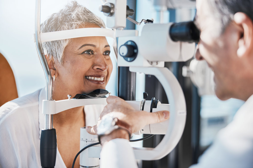 Senior woman, eye exam and optometrist with medical eyes test at doctor consultation. Vision, healthcare focus and old female patient with consulting wellness expert for lens and glasses check.