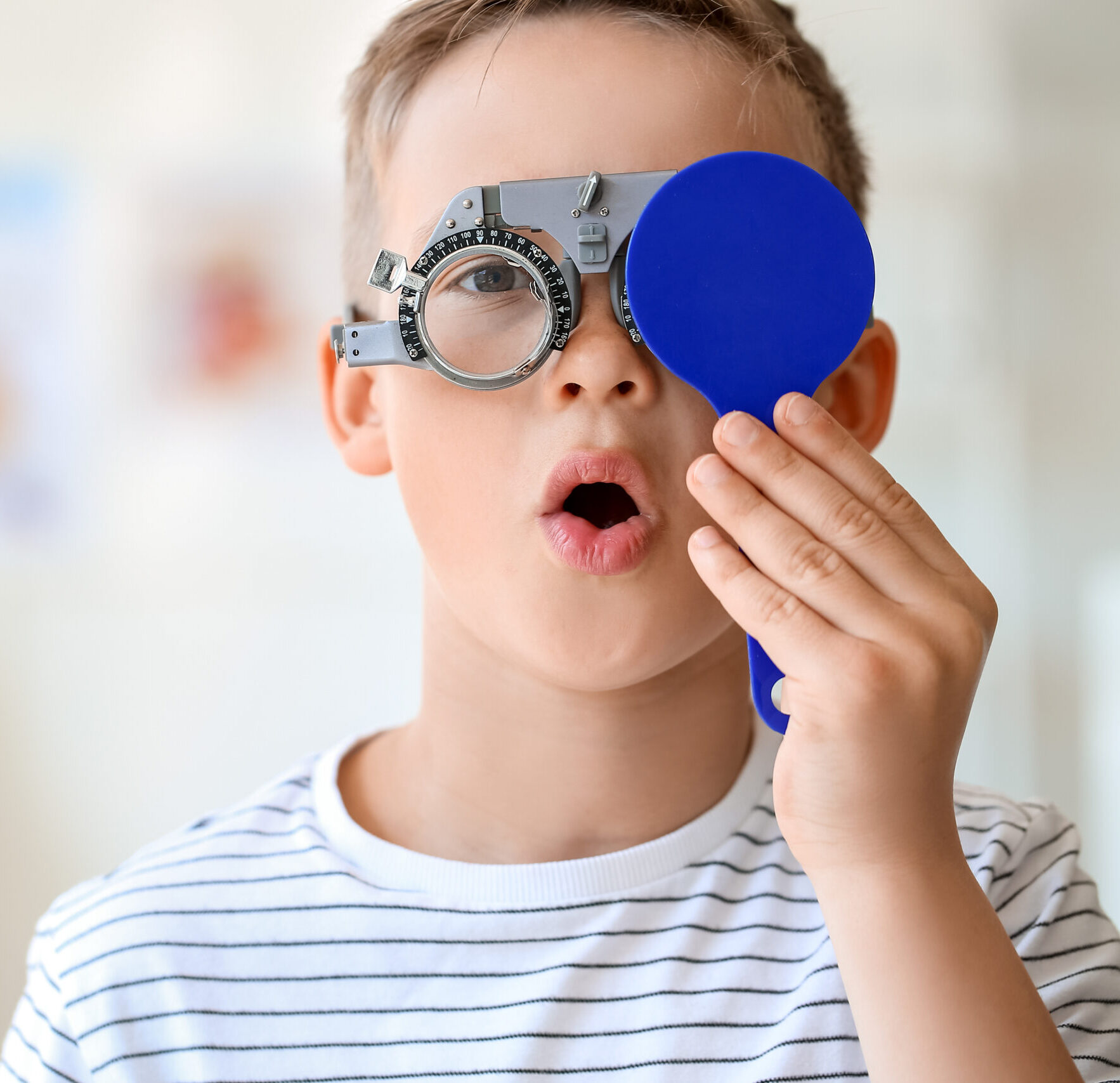 Little boy undergoing eye test in clinic