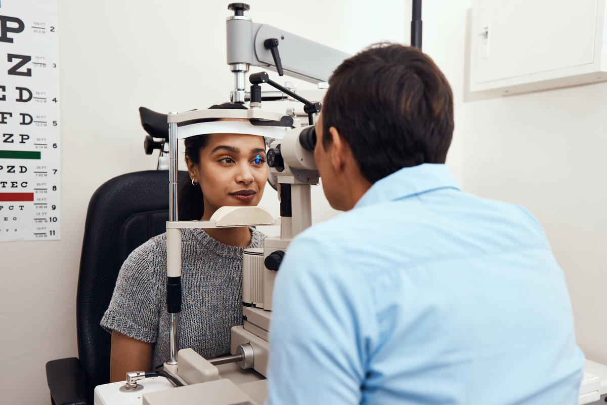 Shot of a young woman getting her eyes examined with a slit lamp by an optometrist