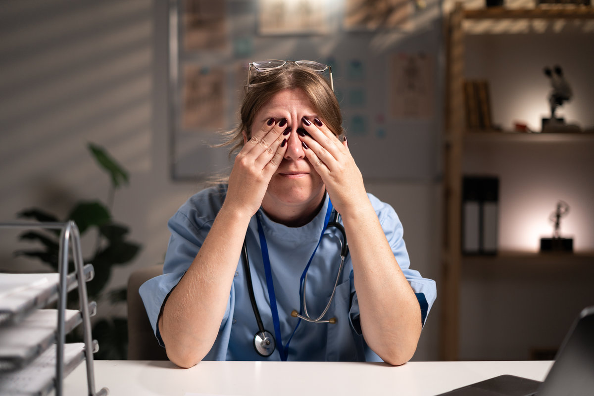 unhealthy physician nurse suffering eye strain working over hours in hospital office on night shift. Medicine and Health care service. concept