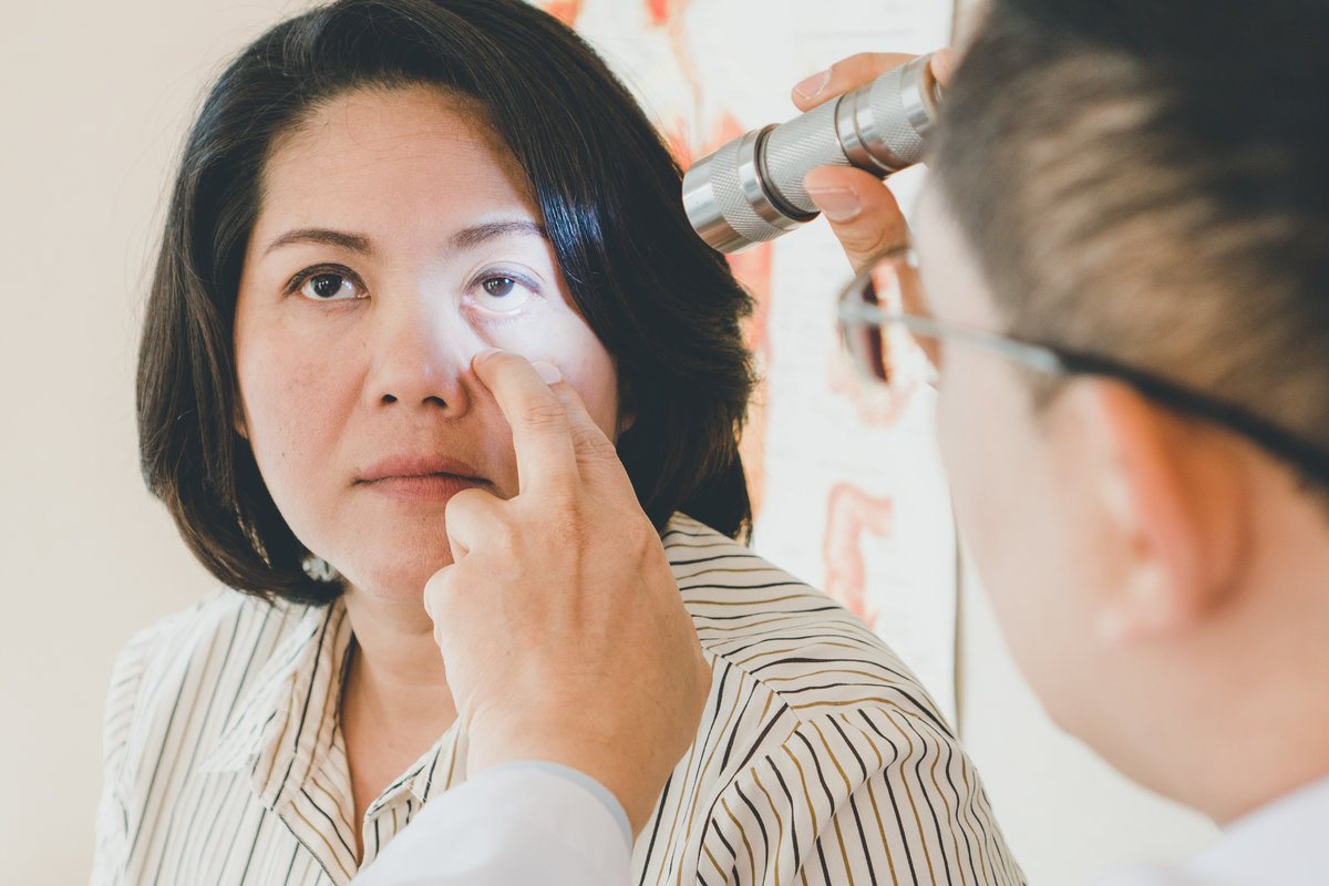 Doctor examining eyes of patient in the clinic.