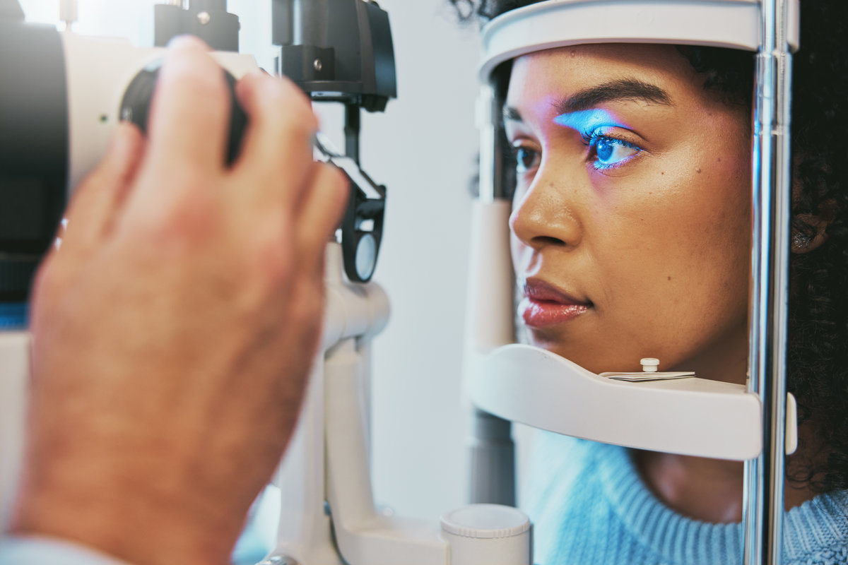 Ophthalmology, healthcare and eye exam with black woman and consulting for vision, medical and glaucoma check. Laser, light and innovation with face of patient and machine for scanning and optometry.