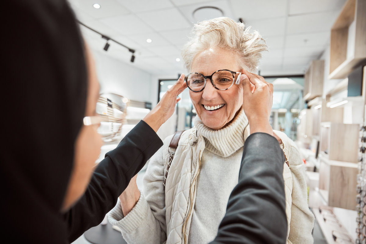 Glasses, vision and optometry with a senior woman in an optician office for prescription lenses. Eyewear, eyesight and fashion with a mature customer buying new frame spectacles at the optometrist.