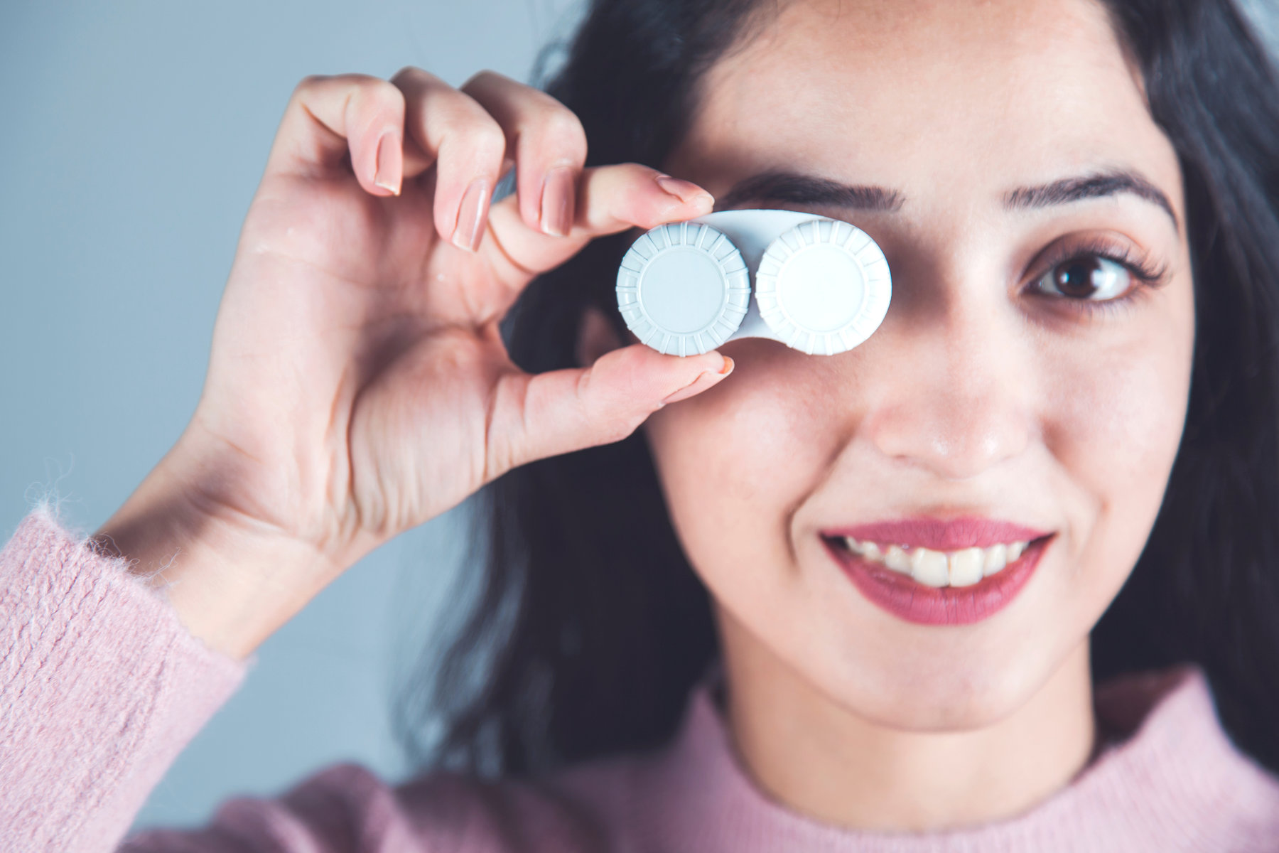 young woman hand holding lenses