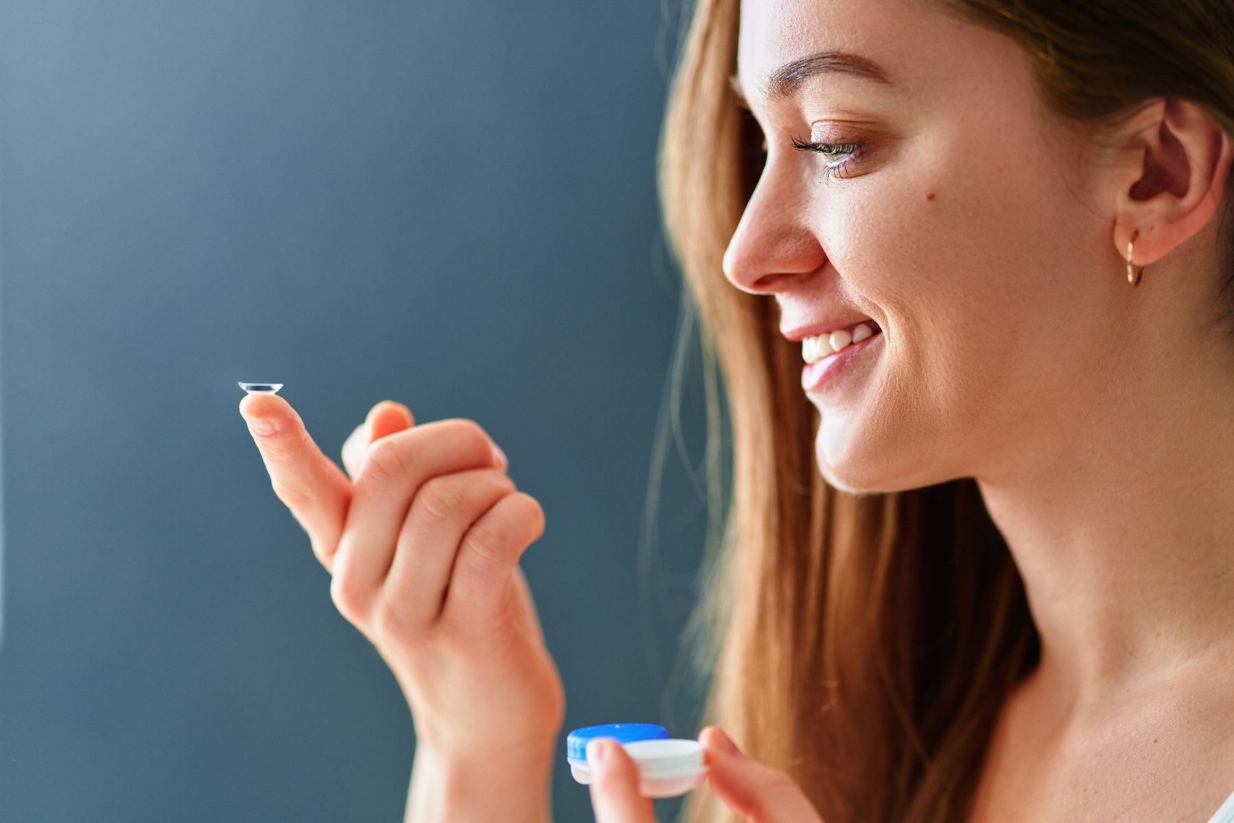 Young woman using soft contact lenses instead of glasses
